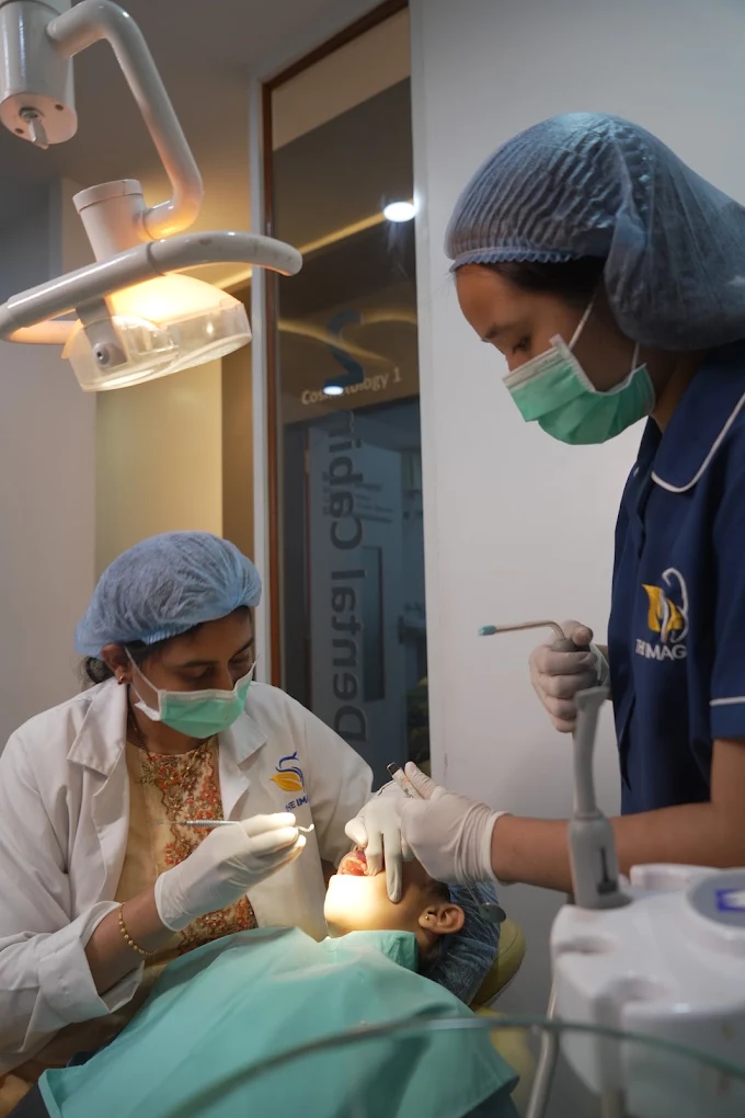 Dentist and assistant treating a young patient